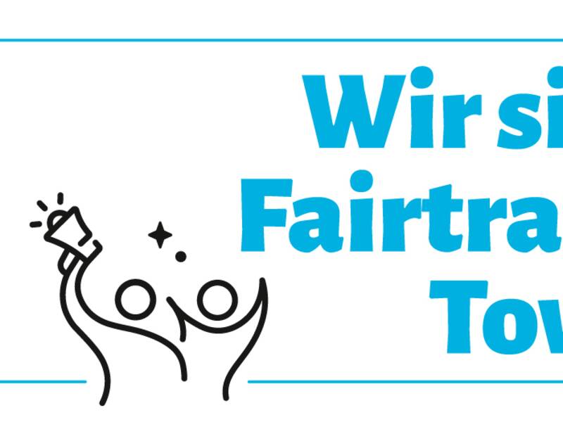 Das Bild zeigt das Logo und den Slogan "Wir sind Fairtrade-Town!" von Horb am Neckar, inklusive einer stilisierten Skyline und dem Fair-Trade-Logo.