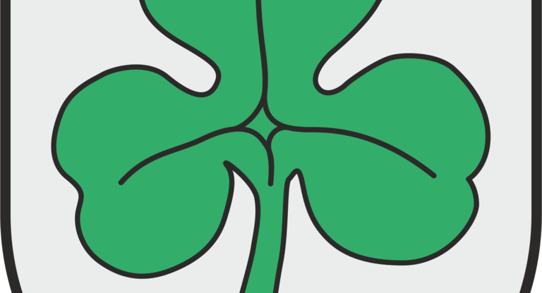 Das Bild zeigt ein Wappen mit einem grünen Kleeblatt auf grauem Hintergrund.