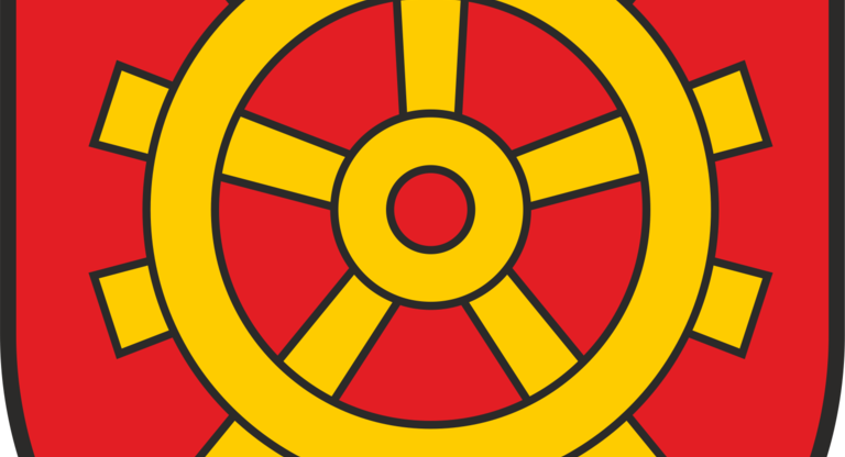 Das Bild zeigt ein Wappen mit einem gelben Zahnrad auf rotem Hintergrund.