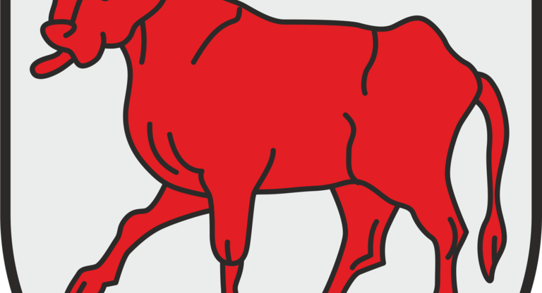 Das Bild zeigt ein Wappen mit einem roten Stier auf einem grauen Hintergrund.