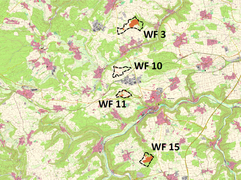 Die Karte zeigt ein ländliches Gebiet mit markierten Zonen, die mit "WF" und Nummern beschriftet sind, umgeben von Straßen und grünen Flächen.