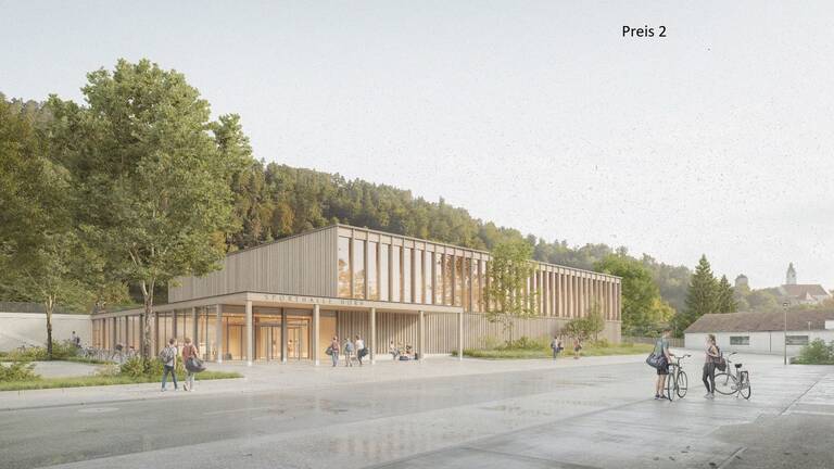 Das Bild zeigt ein modernes Gebäude mit großen Fenstern und der Beschriftung "Sporthalle Horgenzell", umgeben von Bäumen und Menschen, die zu Fuß oder mit dem Fahrrad unterwegs sind.