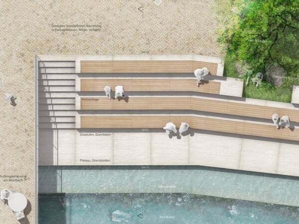 Luftaufnahme eines öffentlichen Sitzbereichs mit Holzstufen und Betonflächen an einem Fluss, umgeben von Bäumen und Gehweg.