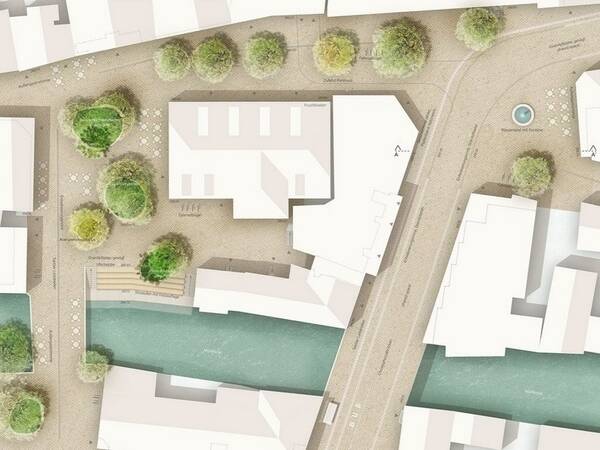 Luftaufnahme eines Stadtplans mit Fluss, Straßen, Gebäuden und Bäumen entlang der Ufer.