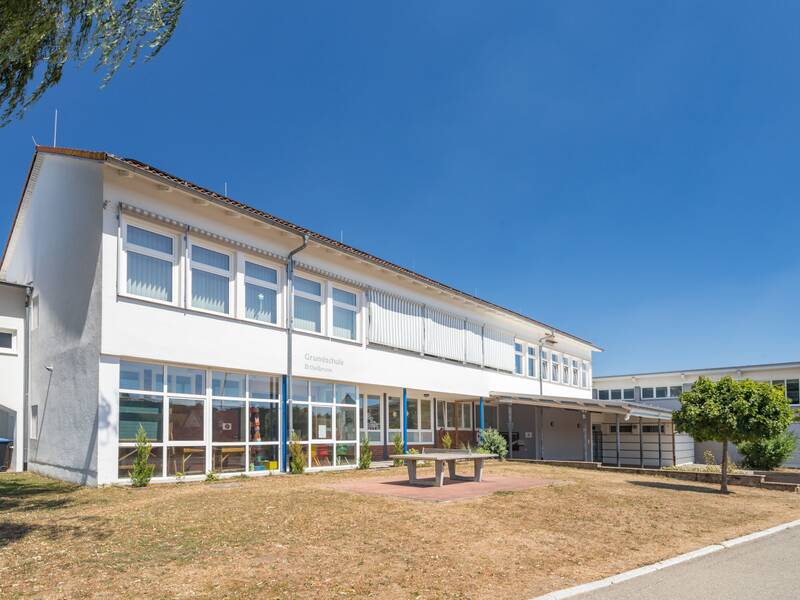 Ein modernes Gebäude mit weißen Wänden und vielen Fenstern.