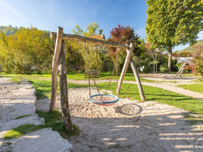 Vogelnestschaukel an Holzgestell auf einem Spielplatz 