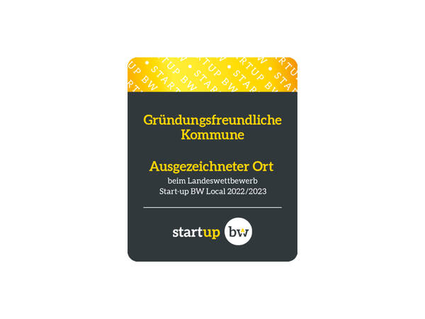 Das Bild zeigt das Logo für Gründungsfreundliche Kommune. Der obere Bildbereich ist in Gelb-gold mit einer weißen Schrift eingefärbt, der untere Bildbereich ist in schwarz eingefärbt und zeigt in Gelb-goldener und weißer Schrift einen Schriftzug
