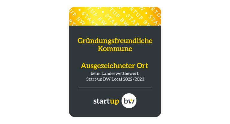 Das Bild zeigt das Logo für Gründungsfreundliche Kommune. Der obere Bildbereich ist in Gelb-gold mit einer weißen Schrift eingefärbt, der untere Bildbereich ist in schwarz eingefärbt und zeigt in Gelb-goldener und weißer Schrift einen Schriftzug