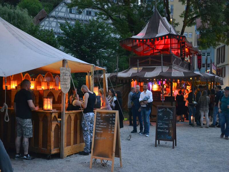 Mehrere Menschen die an einem Stand des Mittelaltermarktes stehen